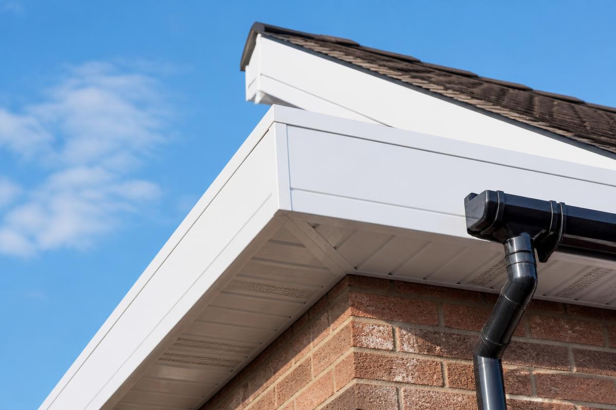 Bright white cleaned fascias and soffits against a blue sky